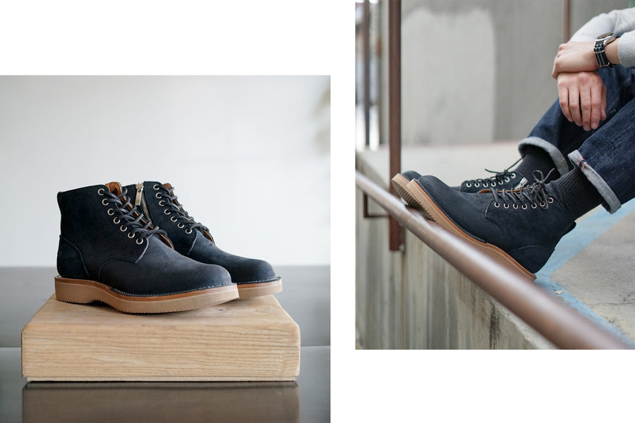The boots sit perched on a wooden block as natural light streams in from the right.