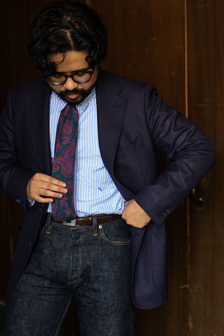 A close up shot of a shirt tucked into a pair of jeans.