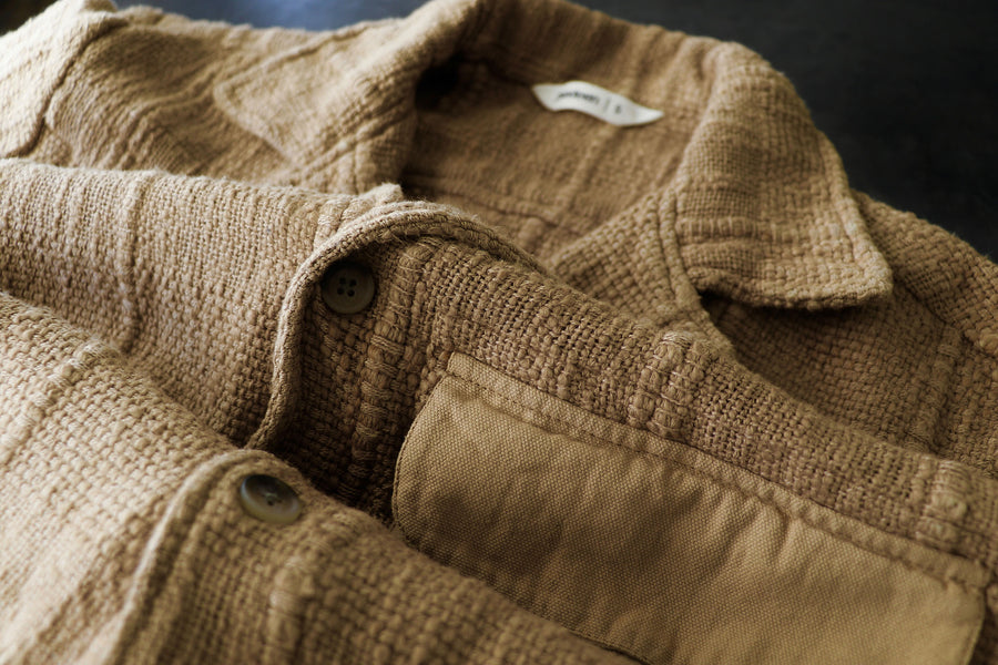 An up close look shows the bumpy texture of the tan shirt.