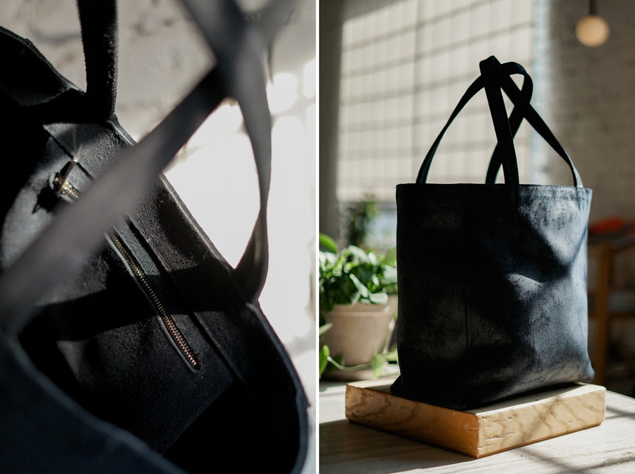 The Viberg tote made out of Charcoal Chamois leather sits in dramatic sunlight inside the 3sixteen store.