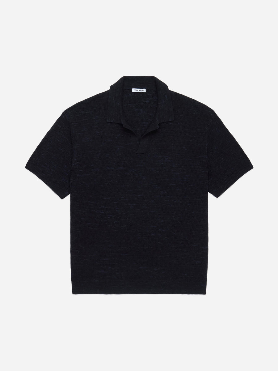 Black polo shirt on a light gray background