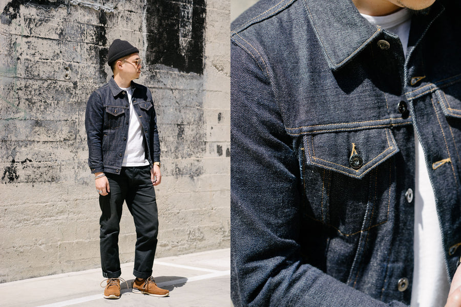 The model wears a 3sixteen denim jacket with a white tee and black pants.