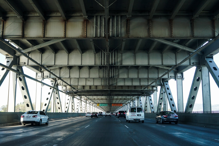 A car drives into a bridge overpass.