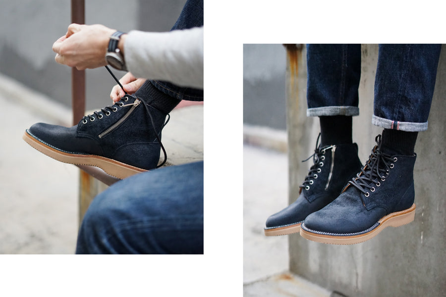 Hands tie the shoelaces of the boots and then the subsequently tied boots hang off a ledge.