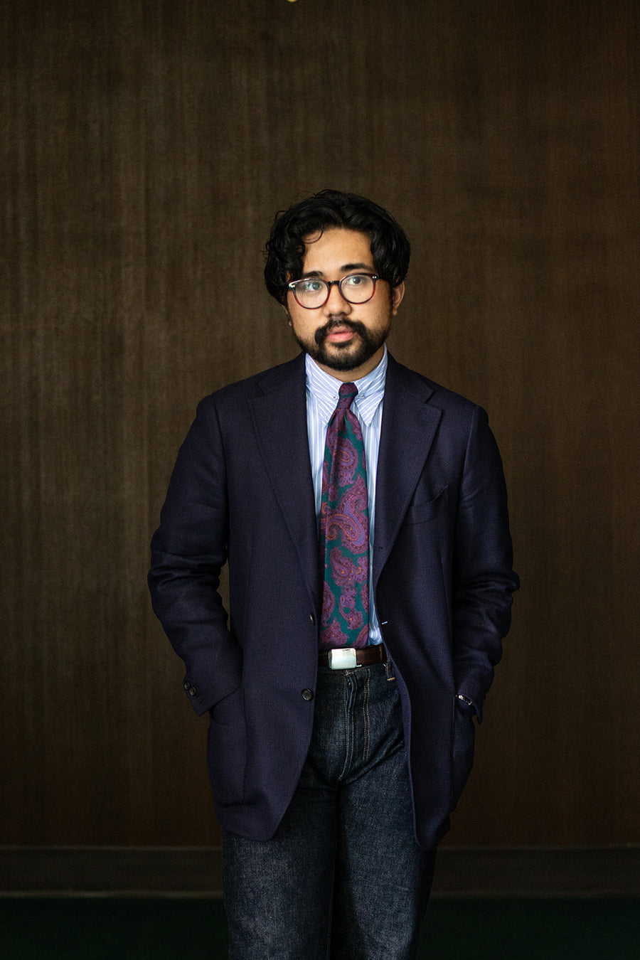 A portrait of a man in a sportcoat, tie, and our CS blue jeans.