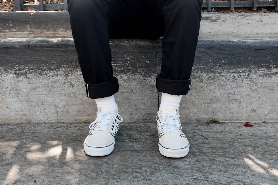 Model is sitting while wearing the 222x, lightweight double black denim