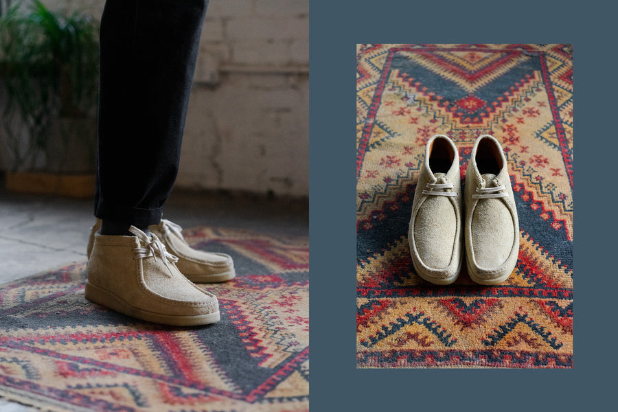 The tan shoes on feet with black pants.