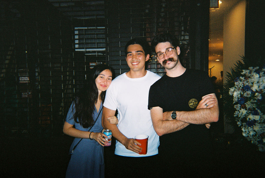 Three friends outside the shop.